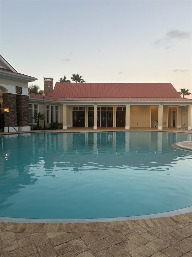 view of pool at dusk