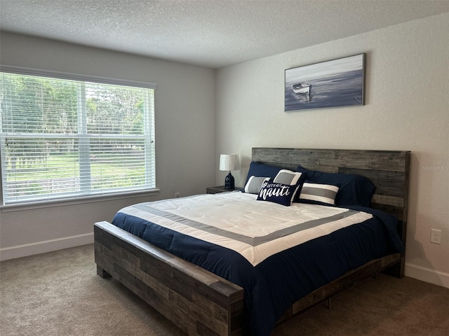 bedroom with light carpet and a textured ceiling