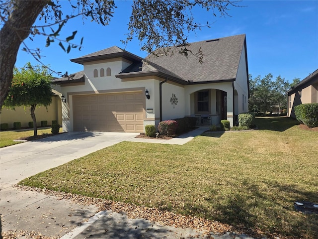 view of front of property with a front yard and a garage