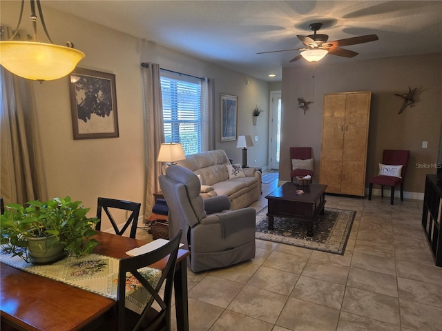 living room with light tile floors and ceiling fan