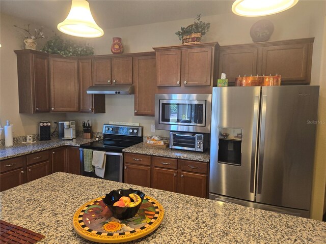 kitchen featuring stainless steel appliances and light stone counters