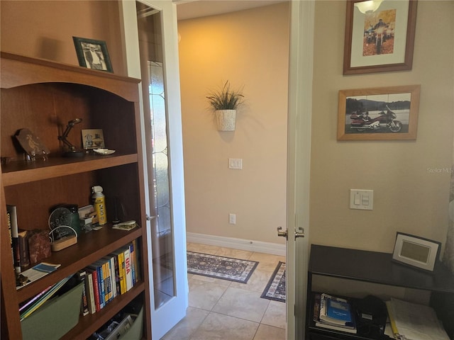 corridor with french doors and light tile floors