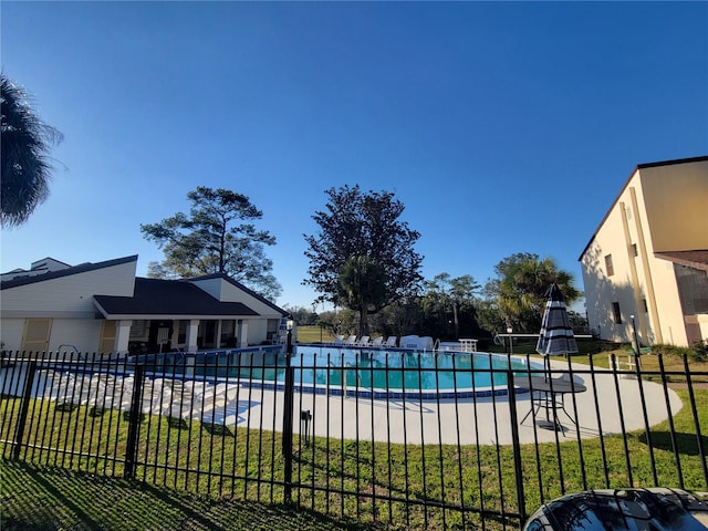 pool featuring a yard and fence