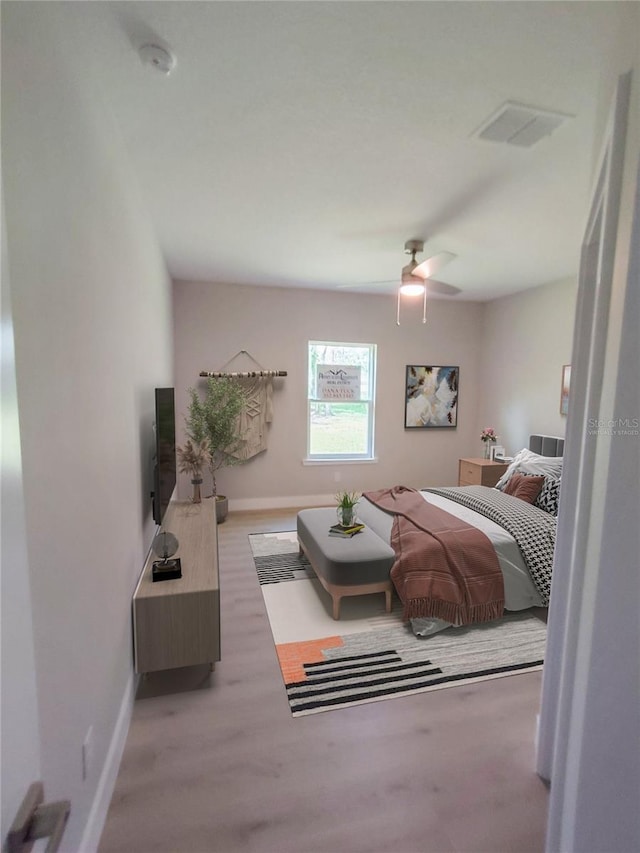 bedroom featuring ceiling fan and light carpet