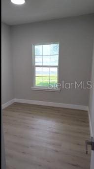 spare room with hardwood / wood-style flooring