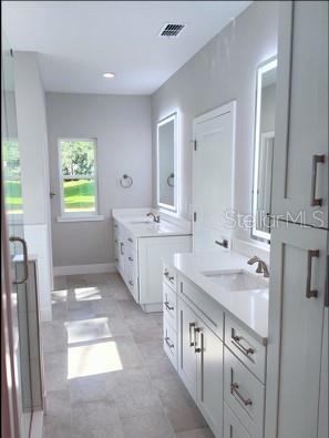 bathroom featuring dual vanity and tile patterned floors