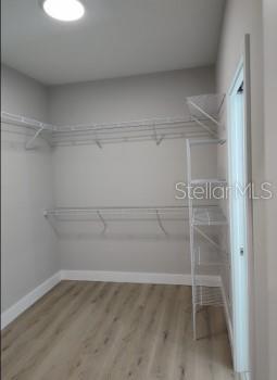 walk in closet featuring hardwood / wood-style floors