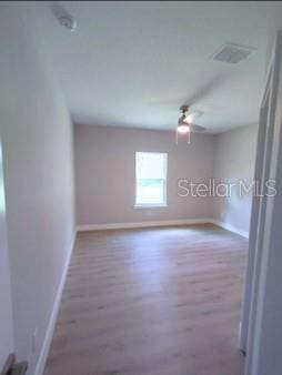 unfurnished room featuring hardwood / wood-style floors and ceiling fan