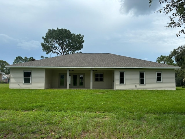 back of house with a lawn