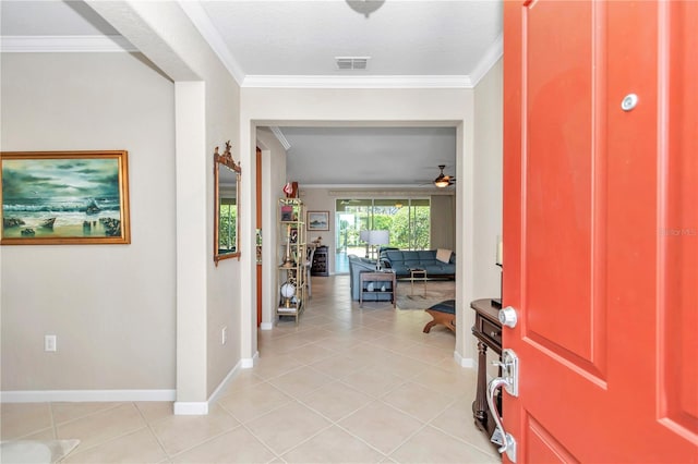 entryway featuring a textured ceiling, ornamental molding, light tile flooring, and ceiling fan