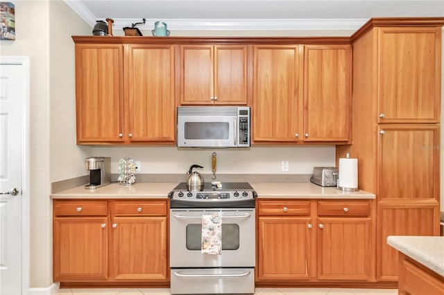 kitchen with light tile floors, crown molding, and electric range