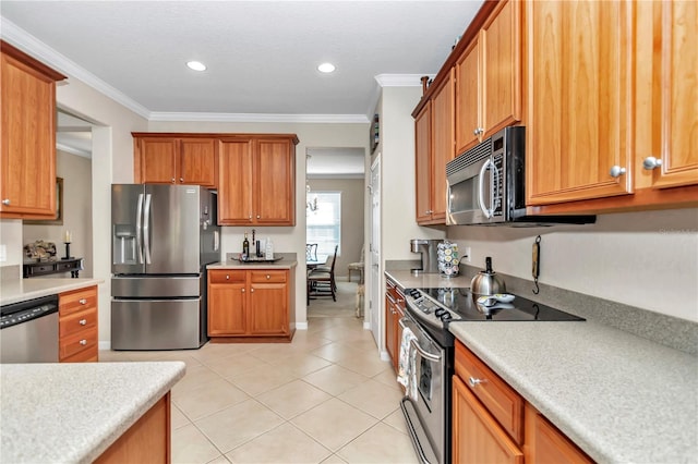 kitchen featuring light tile floors, crown molding, and stainless steel appliances