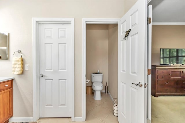 bathroom featuring toilet, tile flooring, vanity, and crown molding