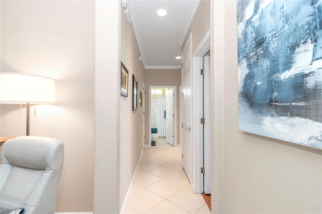 hallway featuring ornamental molding and light tile floors