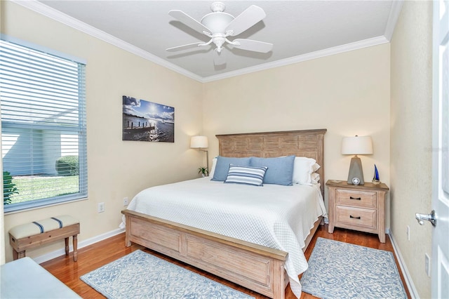 bedroom featuring ceiling fan, dark wood-type flooring, and crown molding