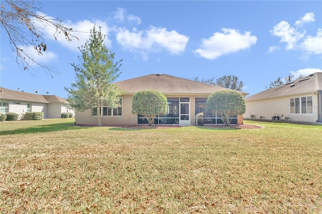 back of property featuring a lawn