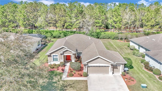 view of front of house with a front lawn and a garage