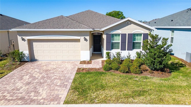 ranch-style home featuring a front lawn and a garage