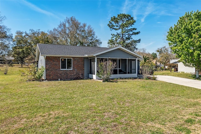 view of front of property featuring a front lawn and a sunroom