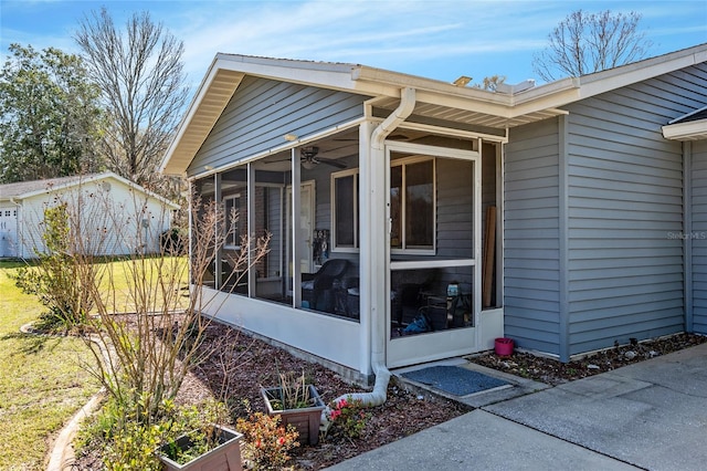 view of side of home featuring a yard and a sunroom