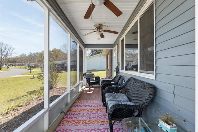 sunroom / solarium featuring ceiling fan