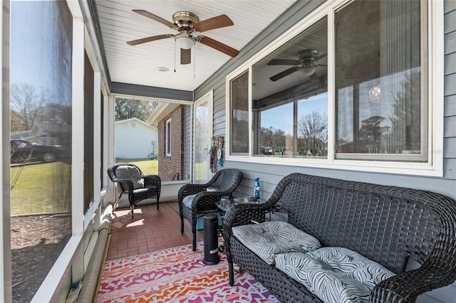 sunroom with ceiling fan and a wealth of natural light