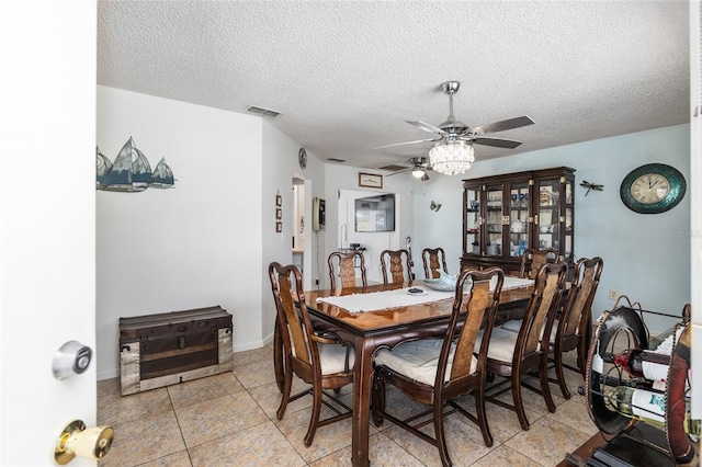 dining space with light tile floors, a textured ceiling, and ceiling fan