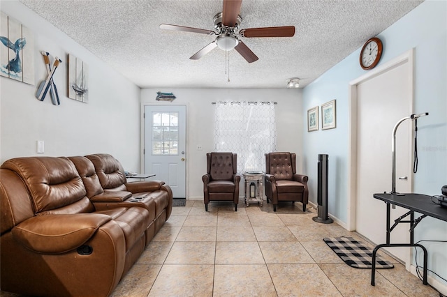 tiled living room with a textured ceiling and ceiling fan