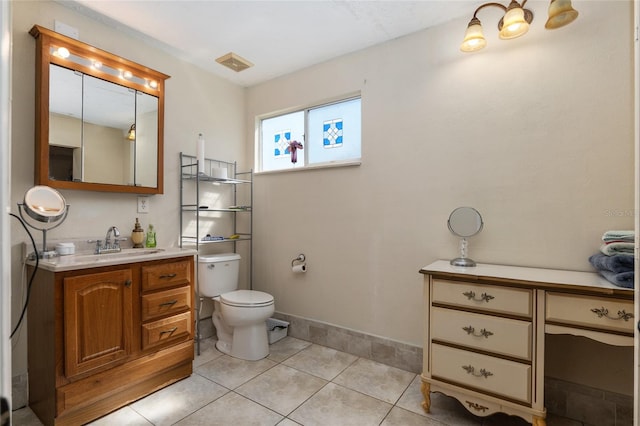 bathroom featuring oversized vanity, toilet, and tile flooring