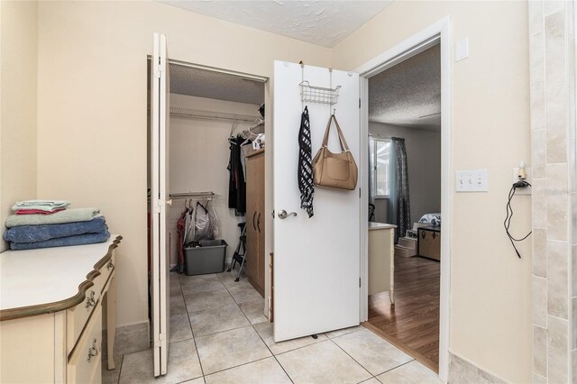 hallway featuring a textured ceiling and light wood-type flooring