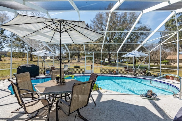 view of swimming pool with a patio and a lanai