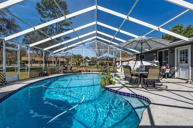 view of swimming pool with a patio area and a lanai