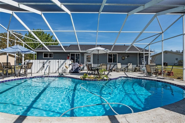 view of pool with a patio area and a lanai