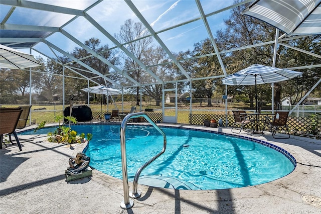 view of swimming pool featuring a patio area, a grill, and a lanai