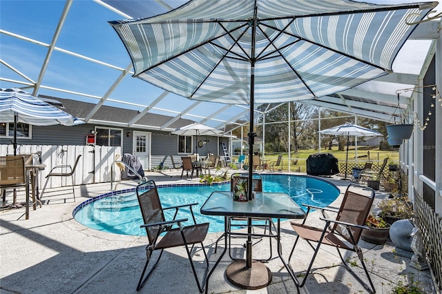 view of swimming pool with a patio area and a lanai