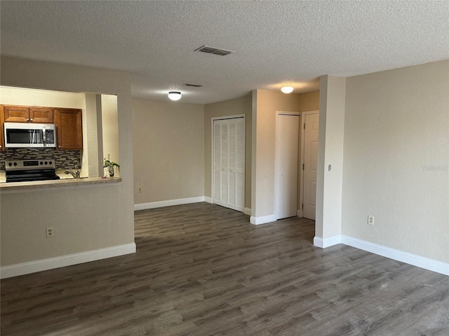 interior space with dark hardwood / wood-style floors and a textured ceiling