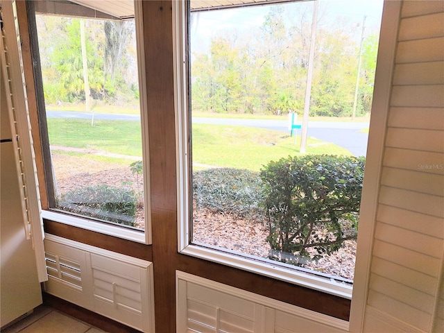 doorway to outside featuring tile patterned floors