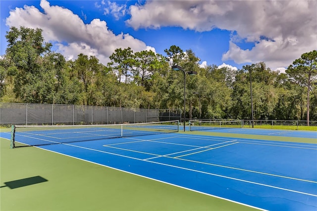 view of tennis court with basketball hoop