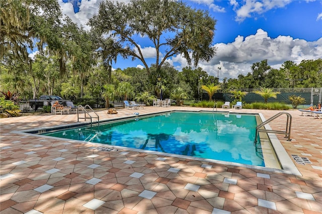 view of swimming pool featuring a patio area