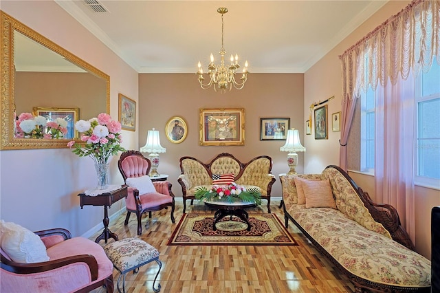 sitting room with crown molding, visible vents, wood finished floors, a chandelier, and baseboards