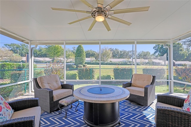 sunroom / solarium featuring a ceiling fan