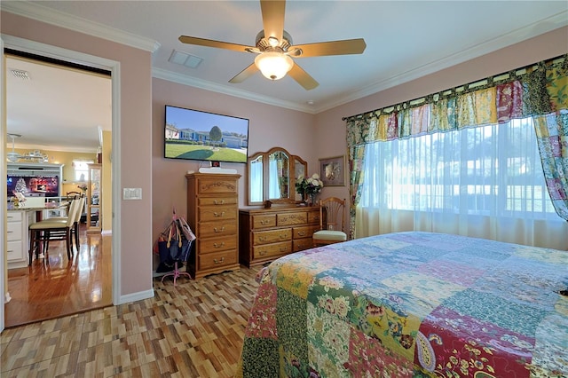 bedroom featuring ornamental molding, light wood-style flooring, and visible vents