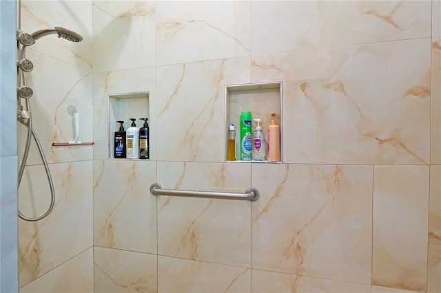 full bath featuring tiled shower