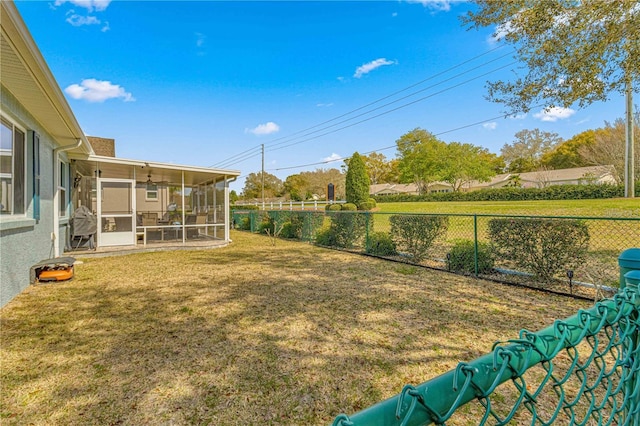 view of yard featuring a fenced backyard and a sunroom