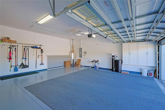 garage with a garage door opener, a ceiling fan, electric panel, and water heater