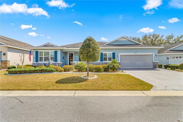 ranch-style house with a garage, driveway, a front lawn, and stucco siding