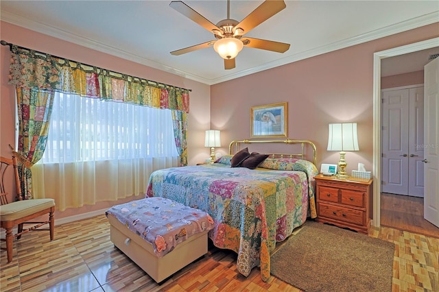 bedroom featuring ceiling fan, baseboards, and crown molding