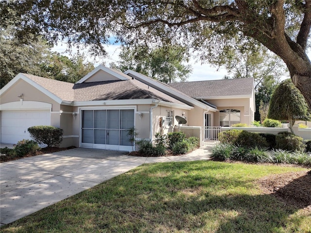 ranch-style house featuring a front yard and a garage