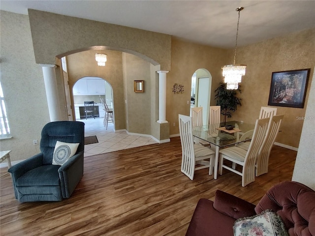 dining area with light tile floors and an inviting chandelier