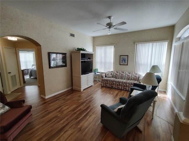 living room featuring dark hardwood / wood-style floors and ceiling fan